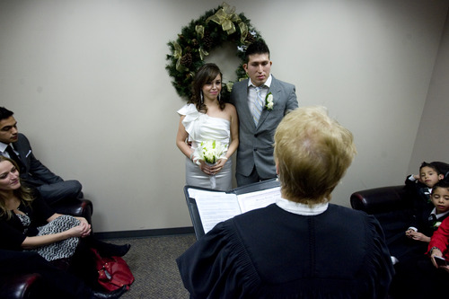 Kim Raff  |  The Salt Lake Tribune
(left) Edna Garcia and J.C. Martinez get married by Deputy Clerk Darlene Von Bank at the Salt Lake County Clerk office in Salt Lake City on December 12, 2012. "Nobody will ever forget this date. We wanted to get married before the end of the world. It's kind of a fun thing," says Garcia of the 12/12/12 date.