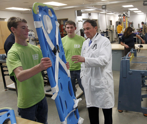 Al Hartmann  |  The Salt Lake Tribune
Gov. Gary Herbert takes a tour of Granite Technical Institute Wednesday after releasing his proposed budget for next year.  Engineering students Skyler Godfrey, left, and Alex Hein show him an easy lift backboard that extends to save the backs of paramedics that would use it.  It was designed and built at GTI.