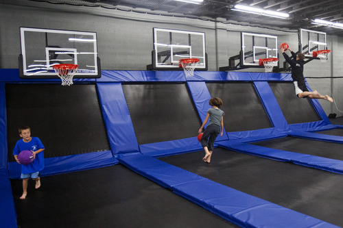 Chris Detrick  |  The Salt Lake Tribune
Kids play with the basketball hoops at the Wairhouse Trampoline Park Tuesday December 4, 2012. The Wairhouse has 15,000 square feet of trampoline area including two full size dodge ball courts, four slam dunk basketball lanes, foam pit and an open jump court.