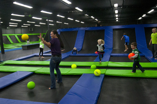Chris Detrick  |  The Salt Lake Tribune
Delia McEwen, of West Jordan, plays dodgeball with her kids and their friends at the Wairhouse Trampoline Park Tuesday December 4, 2012. The Wairhouse has 15,000 square feet of trampoline area including two full size dodge ball courts, four slam dunk basketball lanes, foam pit and an open jump court.