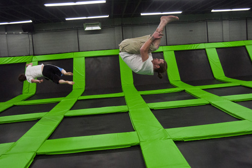 Chris Detrick  |  The Salt Lake Tribune
Taylor Orton and Walter Allred do flips at the Wairhouse Trampoline Park Tuesday December 4, 2012. The Wairhouse has 15,000 square feet of trampoline area including two full size dodge ball courts, four slam dunk basketball lanes, foam pit and an open jump court.
