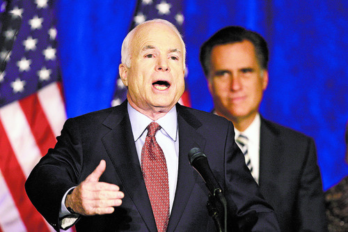 Republican presidential candidate Sen. John McCain, R-Ariz., accompanied by Former Massachusetts Gov. Mitt Romney, gestures as he addresses the media and supporters at the Renaissance Cleveland Hotel in Cleveland, Ohio, Monday, Oct. 27, 2008. (AP Photo/Carolyn Kaster))