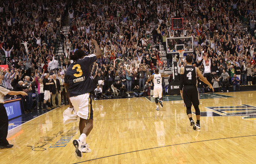 Rick Egan  | The Salt Lake Tribune 

Utah Jazz point guard Mo Williams (5) runs down the court as he celebrates after hitting a 3-point shot at the buzzer to give the Jazz a 99-96 win over the San Antonio Spurs in NBA action, at the Energy Solutions Arena, Wednesday, December 12, 2012.