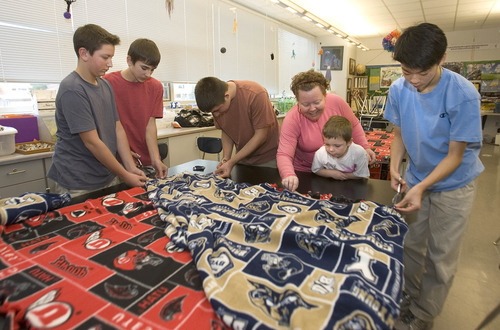 Paul Fraughton  |  The Salt Lake Tribune
Olympus Jr. High students work on on creating University of Utah and BYU blanket throws. The project is one of several projects students are working on that are environmentally minded. The idea behind the blankets is that people who receive them can bundle up in a blanket instead of turning up the thermostat. The students are, from left: Justin Starr, Blake Findley, JT Ontiveros, teacher JoAnne Brown and her son Nevyn Brown, age 6, and Thomas Oh.