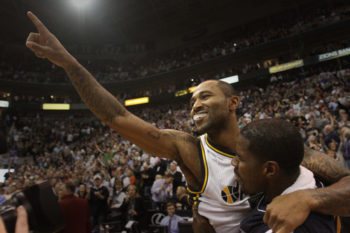 Rick Egan  | The Salt Lake Tribune 

Utah Jazz point guard Mo Williams jumps into the arms of Marvin Williams as he celebrates hitting a 3-point shot at the buzzer to give the Jazz a 99-96 win over the San Antonio Spurs in Salt Lake City on Dec. 12, 2012.