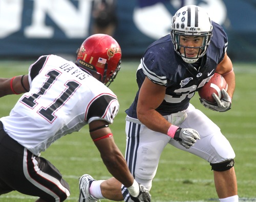 Rick Egan   |  The Salt Lake Tribune

Brayan Kiraya, runs for the Cougars,  in football action, BYU vs. San Diego State, at Lavell Edwards Stadium in Provo,  Saturday, October 9, 2010  Brandon Davis (11) defends for the Aztecs.