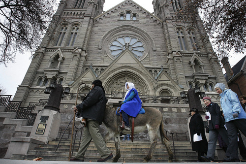 Scott Sommerdorf  |  The Salt Lake Tribune              
Asena Mafua, as "Mary," rides on a donkey led by her father, Maamalaa Mafua, as "Joseph" as the Las Posadas procession leaves the Cathedral of the Madeleine on its way through downtown Salt Lake City. This procession honors the Latin American tradition of Las Posadas, Sunday, December 16, 2012.