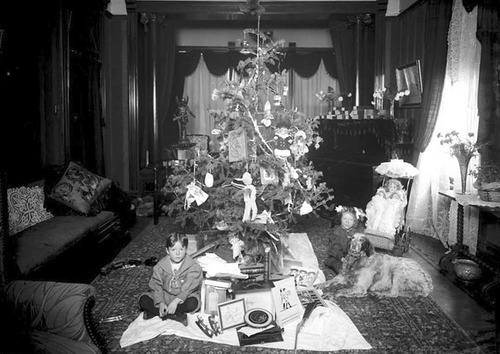 (Photo Courtesy Utah State Historical Society)

Two children and their dog sitting on the floor in front of the Christmas tree in the Windsor V. Rice home, the day after Christmas in 1905.