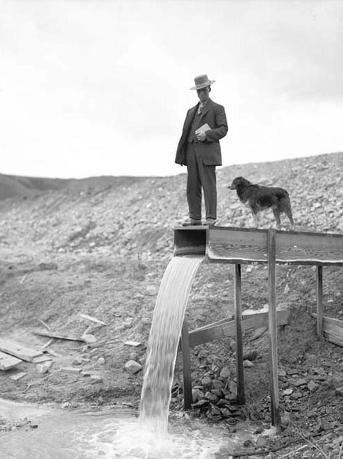 (Photo Courtesy Utah State Historical Society)

A man with his dog at the Utah Copper Company tailings pond in 1907.