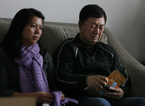 Scott Sommerdorf  |  The Salt Lake Tribune              
Nhuan Phan, right, father of David Phan, cries as he looks through a family photo album containing photos of their son David. David's mother, Phuong Tran is at left. 
The Phan family spoke out for first time, Saturday, December 15, 2012 about why David committed suicide on Nov. 29 at Bennion Junior High.