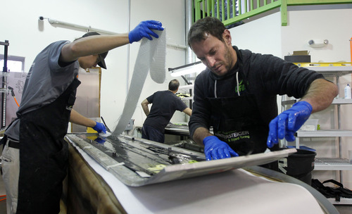 Al Hartmann  |  The Salt Lake Tribune
Production manager Evan Howard, left and "Snow Wizard"-engineer Christian Alary handmake a pair of RAMP skis using layers of bamboo, kevlar and fiberglass.  Instead of compressing the layers together under weight they are  vacuum molded  at their production facility in Park City.