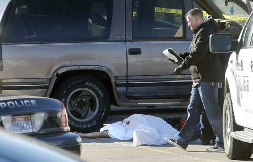 Al Hartmann  |  The Salt Lake Tribune
Forensics experts investigate crime scene on the north side parking lot of Work Force Services at 5680 South Redwood Road where a Unified police officer shot and killed a man who was attacking a woman with a knife in a brown SUV Thursday morning December 20.