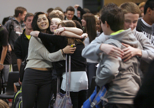 Francisco Kjolseth  |  The Salt Lake Tribune
Jordan High School teens take a moment to hug their neighbor after an assembly entitled "Suicide Shouldn't be a Secret!" on Tuesday, December 18, 2012. Students packed in for an optional assembly where Tanner Kirk, 16, a teen who attempted suicide at the age of 13 and barely survived, spoke to them with the assistance of a speaking computer. When asked how many of them had known of someone who attempted or succeeded in suicide many of the students raised their hands.