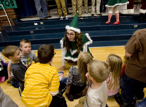 Kim Raff  |  The Salt Lake Tribune
Elf Sierra Bollinger greets children from Monroe Elementary after flying from South Valley Regional Airport with donated supplies on Thursday, Dec. 20, 2012. Twelve pilots joined by Santa and Mrs. Claus flew planes, filled with donated supplies for students at Monroe Elementary, to Richfield Airport from South Valley Regional Airport in West Jordan.