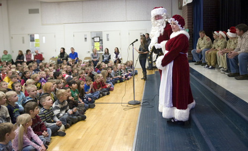 Kim Raff  |  The Salt Lake Tribune
Santa and Mrs. Claus greet children from Monroe Elementary at the school after flying on a "brown reindeer," an A36 Bonanza, with donated supplies on Thursday, Dec. 20, 2012. Twelve pilots joined by Santa and Mrs. Claus flew planes, filled with donated supplies for students at Monroe Elementary, to Richfield Airport from South Valley Regional Airport in West Jordan.