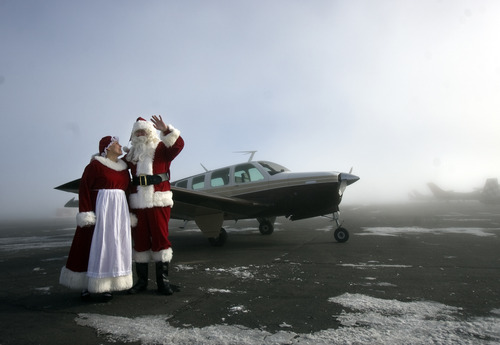 Kim Raff  |  The Salt Lake Tribune
Santa and Mrs. Claus greet children from Monroe Elementary at Richfield Municipal Airport after flying on his "brown reindeer," an A36 Bonanza, with donated supplies for a Santa Flight on Thursday. Twelve pilots joined by Santa and Mrs. Claus flew planes, filled with donated supplies for students at Monroe Elementary, to Richfield Airport from South Valley Regional Airport in West Jordan.