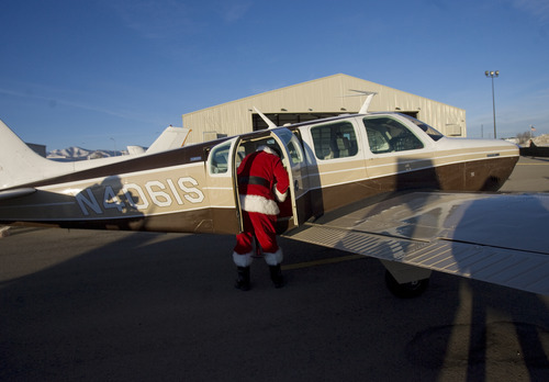 Kim Raff  |  The Salt Lake Tribune
Santa loads donated supplies into his "brown reindeer," an A36 Bonanza, for the Santa Flight at the South Valley Regional Airport on Thursday, Dec. 20, 2012. Twelve pilots joined by Santa and Mrs. Claus flew planes, filled with donated supplies for students at Monroe Elementary, to Richfield Airport from South Valley Regional Airport in West Jordan.