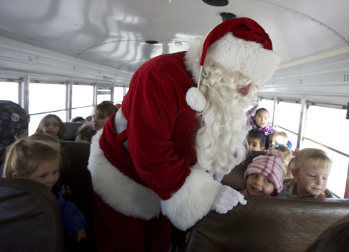 Kim Raff  |  The Salt Lake Tribune
Santa Claus rides with students to Monroe Elementary from Richfield Municipal Airport after Santa flew on his "brown reindeer," an A36 Bonanza, with donated supplies on Thursday, Dec. 20, 2012. Twelve pilots joined by Santa and Mrs. Claus flew planes, filled with donated supplies for students at Monroe Elementary, to Richfield Airport from South Valley Regional Airport in West Jordan.
