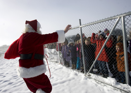 Kim Raff  |  The Salt Lake Tribune
Santa Claus greets children from Monroe Elementary at Richfield Municipal Airport after flying on his "brown reindeer," an A36 Bonanza, with donated supplies for a Santa Flight on Thursday, Dec. 20, 2012. Twelve pilots joined by Santa and Mrs. Claus flew planes, filled with donated supplies for students at Monroe Elementary, to Richfield Airport from South Valley Regional Airport in West Jordan.