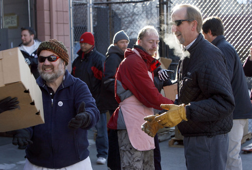 Francisco Kjolseth  |  The Salt Lake Tribune
Forming a human chain, David a.k.a "Papa Bear" (no last name given), Thad Harman and Steve Schindler, from left, unload frozen turkeys provided by Smith's Food & Drug in partnership with Carlson Distributing, distributors of Miller64/Miller Lite. In the absence of a fork lift, numerous volunteers helped unload 5,000 pounds of donated turkey to feed Utah's hungry. Volunteers will be delivering the meat to Dinner at Vinny's (formerly the Salvation Army Soup Kitchen) at the St. Vincent de Paul Dining Hall, 437 W. 200 South. The charitable kitchen was struggling to supply ample meat for their evening stews. This generous donation of 350 turkeys by Smith's and Carlson Distributing will provide about 15,000 servings of protein – or 25 days of meals for 600 people.