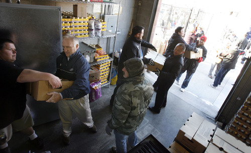 Francisco Kjolseth  |  The Salt Lake Tribune
Smith's Food & Drug in partnership with Carlson Distributing, distributors of Miller64/Miller Lite, show their holiday spirit as volunteers unload 5,000 pounds of donated turkey to feed Utah's hungry. Volunteers will be delivering the meat to Dinner at Vinny's (formerly the Salvation Army Soup Kitchen) at the St. Vincent de Paul Dining Hall, 437 W. 200 South. The charitable kitchen was struggling to supply ample meat for their evening stews. This generous donation of 350 turkeys by Smith's and Carlson Distributing will provide about 15,000 servings of protein – or 25 days of meals for 600 people.