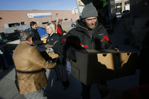 Francisco Kjolseth  |  The Salt Lake Tribune
Forming a human chain Lyle Rowley joins other volunteers to unload frozen turkeys provided by Smith's Food & Drug in partnership with Carlson Distributing, distributors of Miller64/Miller Lite. In the absence of a fork lift, numerous volunteers helped unload 5,000 pounds of donated turkey to feed Utah's hungry. Volunteers will be delivering the meat to Dinner at Vinny's (formerly the Salvation Army Soup Kitchen) at the St. Vincent de Paul Dining Hall, 437 W. 200 South. The charitable kitchen was struggling to supply ample meat for their evening stews. This generous donation of 350 turkeys by Smith's and Carlson Distributing will provide about 15,000 servings of protein – or 25 days of meals for 600 people.