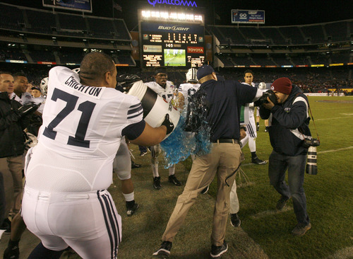 Rick Egan  | The Salt Lake Tribune 

 Brigham Young Cougars head coach Bronco Mendenhall avoids the gatorade dumped by Tui Crichton (71) as time runs out, as BYU defeats San Diego State in the Poinsettia Bowl, Thursday, December 20, 2012.