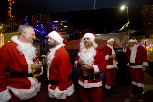 Kim Raff  |  The Salt Lake Tribune
(from left) Scott Sullidant, Larry Tucker, and Oliver Ulibarri hang out on the patio at Gracie's Bar during the first stop of the SantaCon 2012 pub crawl in Salt Lake City on December 22, 2012.