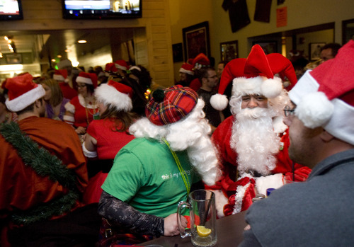 Kim Raff  |  The Salt Lake Tribune
(middle green) Brian Isom and (right) Rick Richey join a large group of people dressed as Santa Claus or in festive Christmas costumes at Gracie's Bar for the first stop of SantaCon 2012 pub crawl in Salt Lake City on December 22, 2012.