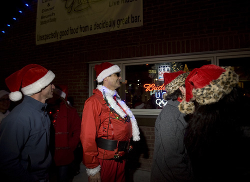 Kim Raff  |  The Salt Lake Tribune
People dressed as Santa Claus wait to get into Gracie's Bar during the  SantaCon 2012 pub crawl in Salt Lake City on December 22, 2012.