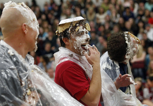 Al Hartmann  |  The Salt Lake Tribune
School policeman Scott Lauritzen, left, Vice Principal Mike Chritensen and Vice Principal Lynn Allred get "pied" during a skit at Herriman High School Hearts of Gold closing assembly on Friday December 21.   The assembly celebrated the season charity drive with everything from a dodge ball championship match to dances and student body skits. Through prior student donations and today's assembly the school raised $30,012,56 for charity.