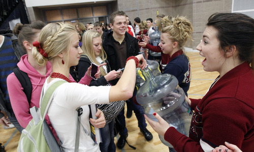 Al Hartmann  |  The Salt Lake Tribune
Students at Herriman HIgh School donate money to student body officers as they enter the gym for Hearts of Gold closing assembly on Friday December 21.   The assembly celebrated the season charity drive with everythng from a dodge ball championship match to dances and student body skits. Through prior student donations and today's assembly the school raised $30,012,56 for charity.