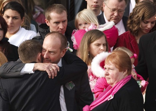 Leah Hogsten  |  The Salt Lake Tribune
Robbie Parker carries daughter Madeline, 4,  and Alissa Parker carries Samantha, 3, from the funeral service for their oldest daughter Emilie, Saturday December 22, 2012 in Ogden. Funeral services for Connecticut elementary shooting victim Emilie Parker were held in Ogden at the at the Rock Cliff LDS Stake Center. Emilie, whose family has Ogden roots, was one of 20 children and six adult victims killed in the Dec. 14 mass shooting at Sandy Hook Elementary in Newtown, Conn. The shooting took the lives of 26 people, before the gunman killed himself.