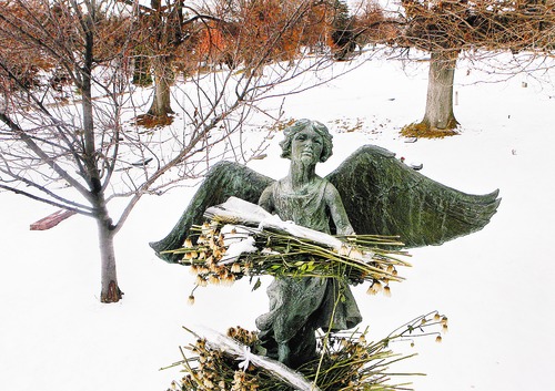 Scott Sommerdorf  |  Salt Lake Tribune
ANGELS IN SLC
The "Christmas Box Angel" in the Salt Lake Cemetery. Visitors to the cemetery have adorned the angel with flowers that have since wilted.
