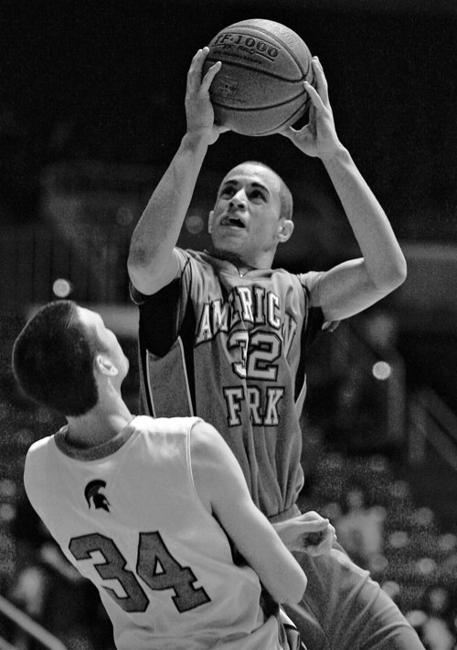 Djamila Grossman  |  The Salt Lake Tribune

American Fork High School's Quincy Bair (32) pushes over Murray High School's David Collette (34) in the second half of a State Championship semifinal at Weber State University in Ogden, Utah, on Friday, March 4, 2011. American Fork won the game.