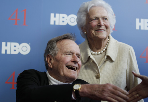 FILE - In a Tuesday, June 12, 2012 file photo, former President George H.W. Bush, and his wife, former first lady Barbara Bush, arrive for the premiere of HBO's new documentary on his life near the family compound in Kennebunkport, Maine. Bush spokesman Jim McGrath said Wednesday, Dec. 26. 2012 that doctors at the Houston hospital where Bush has been treated for a month remain "cautiously optimistic" that he will recover. Still, no discharge date has been set, and McGrath says that doctors are being cautious because at Bush's age "sometimes issues crop up that are beyond anybody's ability to discern or foretell."(AP Photo/Charles Krupa, File)