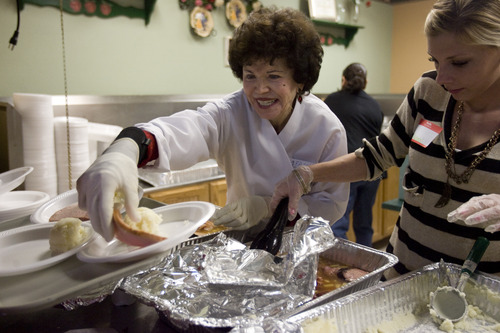 Kim Raff  |  The Salt Lake Tribune
Volunteer Jeannie Johnson helps to prepare plates of food during the Salt Lake City Mission's Christmas day meal at the Christian Life Center in Salt Lake City on December 25, 2012.  Johnson volunteers with the SLC Mission six times a year and helps to serve food.