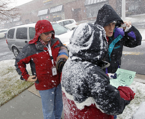 Al Hartmann  |  The Salt Lake Tribune
Homeless advocate Pamela Atkinson, right, and Ed Snoddy, medical outreach coordinator for Volunteers of America, left, check in with a homeless woman in Sugarhouse during a snowstorm Monday December 24 to see if she allright.  She needed a warm blanket and hot meal and got an invitation to a steak dinner on Christmas day.  The two visited homeless people around Salt Lake City offering hot meals, boots, and warm clothing to help get them through the cold weather.