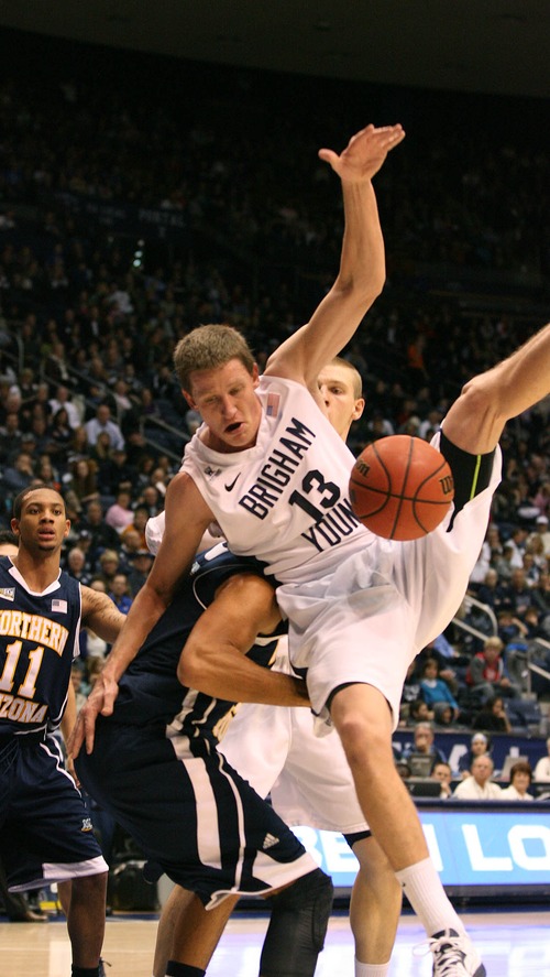 Paul Fraughton  |   Salt Lake Tribune
 BYU's Brock Zylstra  takes an awkward fall as he is fouled by NAU's Gaellan Bewernick.  BYU played Northern Arizona University at The Marriott Center in Provo.
 Thursday, December 27, 2012