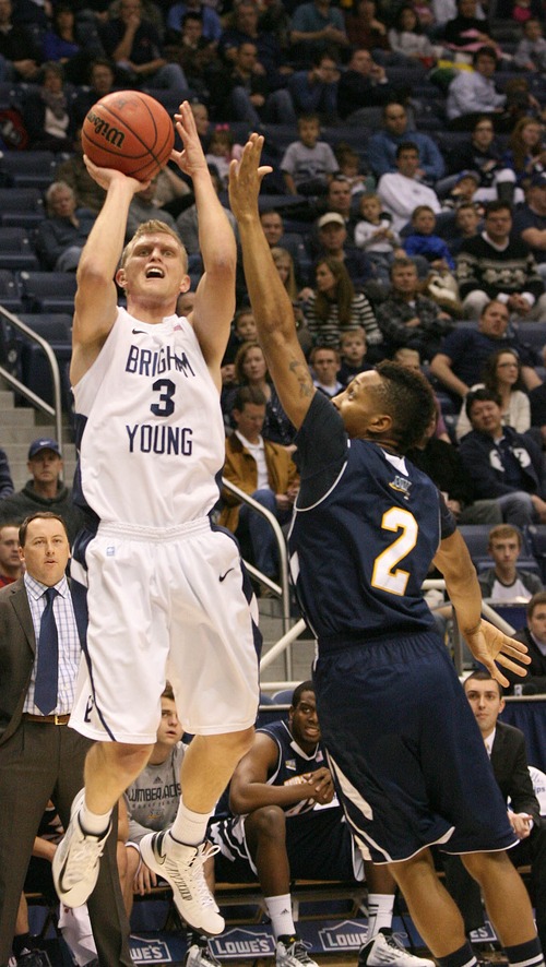 Paul Fraughton  |   Salt Lake Tribune
BYU's Tyler Haws launches a three point shot  as NAU's Michael Dunn defends. BYU played Northern Arizona University at The Marriott Center in Provo.
 Thursday, December 27, 2012
