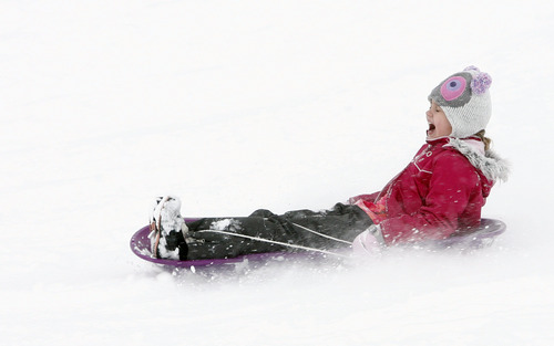 Rick Egan  | The Salt Lake Tribune 

Eight-year-old Audrey Owens enjoys the new snow as she sleds on a hill near Mueller Park Jr. High in Bountiful on Friday, Dec. 28, 2012.