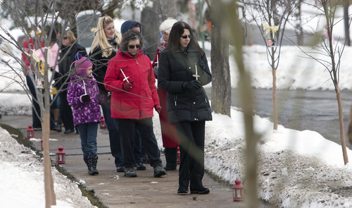 Steve Griffin |  The Salt Lake Tribune
Salt Lake City officials are joined by the public as they walk through a new grove of eastern redbud trees dedicated Thursday in memory of the victims of the Newtown, Conn., shootings at the entrance to the Salt Lake City Cemetery Thursday December 27, 2012.