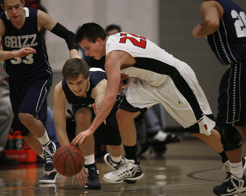Scott Sommerdorf   |  The Salt Lake Tribune
Copper Hills' Mitch Eyre, left fights Caveman Kyle Line for a loose ball during first half play. American Fork beat Copper Hills 48-39 in the Jordan Holiday Tournament, Thursday, December 27, 2012.