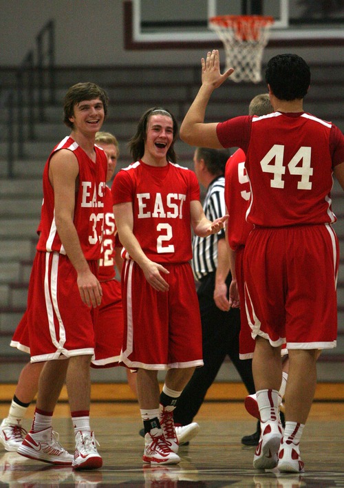 Leah Hogsten  |  The Salt Lake Tribune
East's Mitch Grant, Jake Bero-vw and Pa'a Montalbo slap hands at a technical foul given to American Fork. East High School mens basketball team defeated American Fork 85-74 during their quarterfinal game at the Jordan Holiday boys' basketball tournament at Jordan High School Friday December 28, 2012 in Sandy.