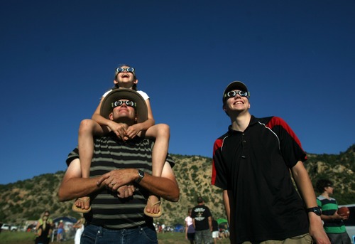 Kim Raff | The Salt Lake Tribune
(top) Marissa, (bottom) Jon and (right) Michael Wikan watch the annular solar eclipse at the public viewing area in Kanarraville, Utah on May 20, 2012. Kim Raff | The Salt Lake Tribune