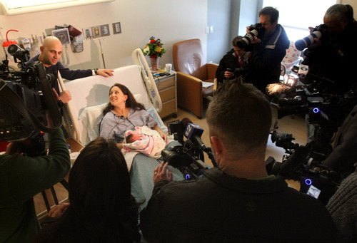 Rick Egan  | The Salt Lake Tribune 

Monica  Rossano holds little Anna-Sofia Rossano in the Gardner Women and Newborn Center at the Intermountain Medical Center in Murray, Tuesday, January 1, 2013. Anna-Sofia was born at 12:01am Tuesday. Salvatore Rossano is the father standing behind the bed.