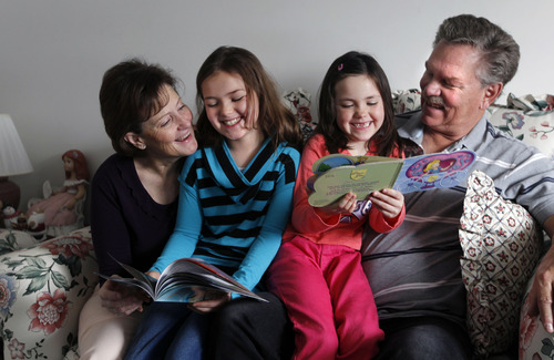 Al Hartmann  |  The Salt Lake Tribune
Vickie and Ray Ipson read chapter books with their grandchildren Civic, 9 and Genessa, 7,   They are rasing them and have legally adopted them after their daughter lost custody of the two girls. The Ipsons credit the Grandfamilies program with helping them deal with their new reality.