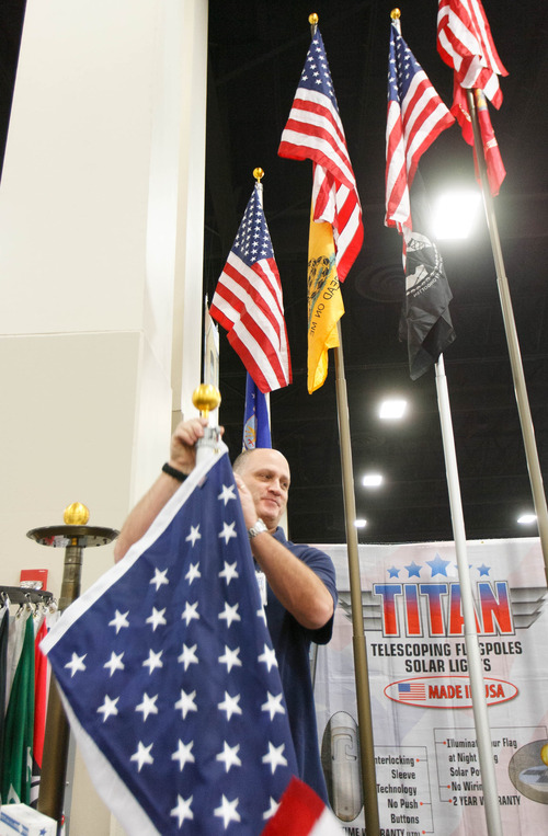 Trent Nelson  |  The Salt Lake Tribune
Ernie Gentile of Pacific Flag and Pole raises a flag at the Salt Lake Home Show Friday January 4, 2013 in Sandy.