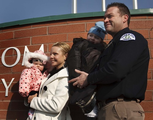 Leah Hogsten  |  The Salt Lake Tribune
Ogden police Officer Kasey Burrell, who was wounded the night fellow Weber-Morgan Narcotics Strike Force team member Jared Francom died, has his picture taken in front of the building with his wife Natalie and daughters Kennedy, 3, and Jersey, 6 months. The Ogden Public Safety Building was renamed the Francom Public Safety Center on, Friday Jan. 4, 2013 in Ogden, in honor of agent Jared Fracom, who was killed a year ago while serving a search warrant.