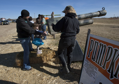 Steve Griffin |  The Salt Lake Tribune
James Badger and his daughter, LuLu, shoot a pumpkin cannon at a corn maze in Bluebell, Utah. The Badgers where reunited with Ashley Maynard's family at the maze Saturday, October 27, 2012. Maynard, 12, died in 2010. Her liver saved LuLu's life. The two families have become friends and met in the small Utah town for the kids to visit the maze and visit Ashley's grave in Vernal.